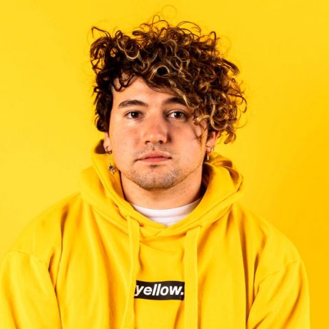 JC Caylen in a yellow t-shirt.